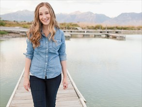 Portrait of young woman on jetty. Photo : Jessica Peterson