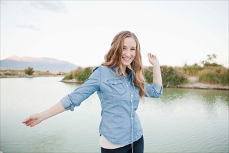 Portrait of young woman dancing player by lake. Photo : Jessica Peterson
