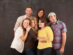Studio portrait of group of friends embracing. Photo : Jessica Peterson