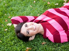 Portrait of woman lying on grass. Photo: Jessica Peterson