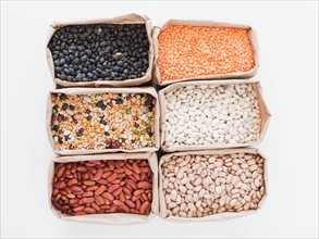 Assorted beans on white background. Photo : Jessica Peterson