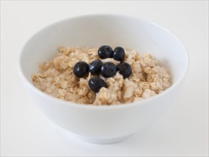 Oatmeal with blueberries on white background. Photo: Jessica Peterson