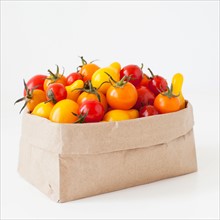 Studio Shot of Cherry Tomatoes in paper bag. Photo : Jessica Peterson