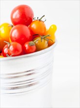Studio Shot of Cherry Tomatoes in plastic container. Photo : Jessica Peterson