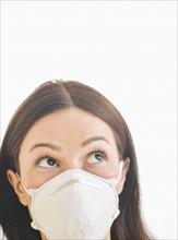 Studio portrait of woman wearing flu mask.
