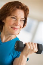 Senior woman lifting weights.