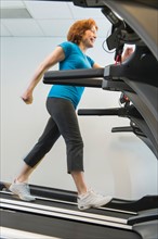 Senior woman on treadmill.