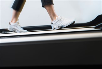Low section of woman on treadmill.