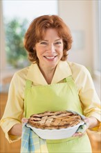 Senior woman baking pie.
