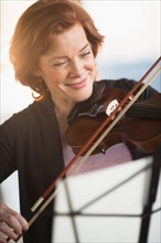Senior woman playing violin.