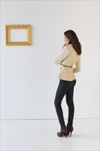Woman looking at picture in art gallery.