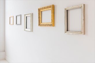 Empty picture frames in art gallery.