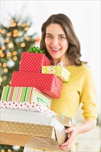 Woman holding christmas gifts.