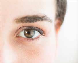 Close up of young woman's eye, studio shot.