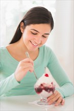 Teenage girl (16-17) eating ice-cream.