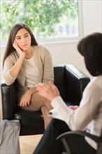 Teenage girl (16-17) talking to therapist.