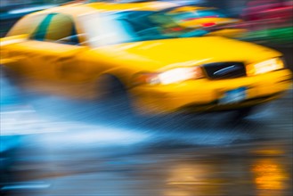 Yellow cab in blurred motion.