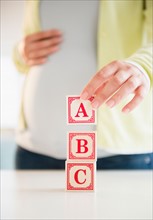 Pregnant woman playing with bricks
