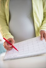 Pregnant woman with calendar