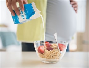 Pregnant woman preparing breakfast