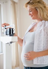 Pregnant woman on weighting scales