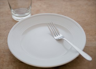White plate with fork and glass