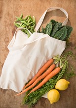 Studio shot of organic vegetables in shopping bag
