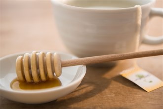 Studio shot of tea cup and honey spoon