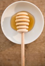 Studio shot of honey on saucer