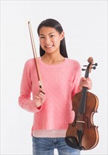 Portrait of teenage girl ( 16-17 years) holding violin