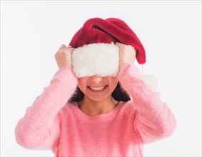 Portrait of teenage girl (16-17 years) wearing santa hat