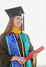 View of graduate student holding diploma