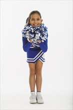 Portrait of cheerleader ( 10-11 years) holding pom-pom