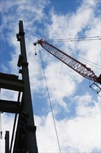 Upward view of crane and construction