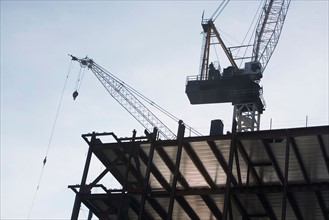 Low angle view of crane and building under construction