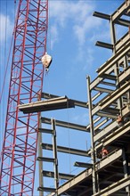 Crane lifting parts of metal frame