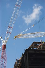 Low angle view of crane and construction frame