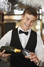 Waiter pouring champagne into champagne flute