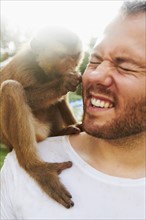 Portrait of man holding monkey