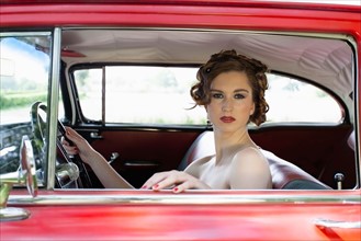 Portrait of elegant woman in vintage car