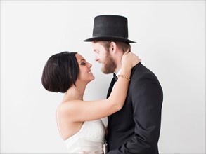 Studio Shot portrait of bride and groom smiling face to face