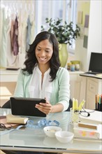 Female entrepreneur using digital tablet.