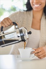 Woman pouring coffee.