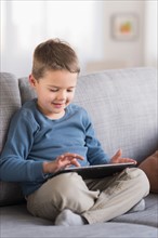 Boy (4-5) using tablet pc.