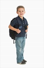 Portrait of schoolboy (4-5) carrying backpack.