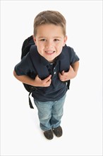 Portrait of schoolboy (4-5) carrying backpack.