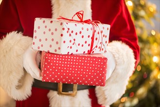 Santa claus holding presents.