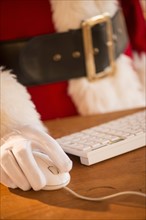 Close-up of santa claus using computer.