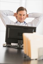 Office worker relaxing in front of computer.