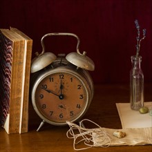 Still life with antique clock and books.
